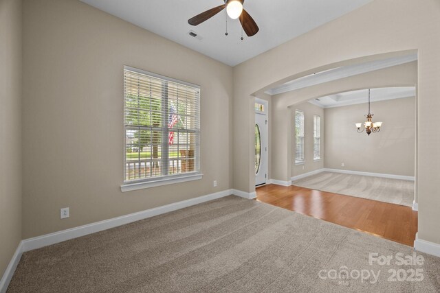 10349 Alvarado Way, Charlotte, NC 28277 - unfurnished room with carpet flooring, a chandelier, a ceiling fan, and arched walkways