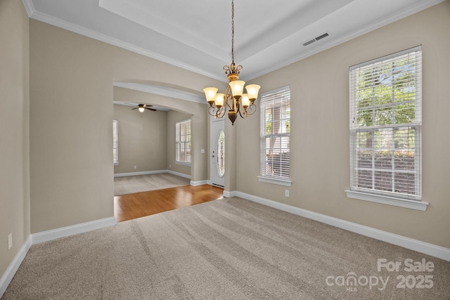 10349 Alvarado Way, Charlotte, NC 28277 - carpeted spare room featuring a chandelier, a ceiling fan, crown molding, arched walkways, and a tray ceiling