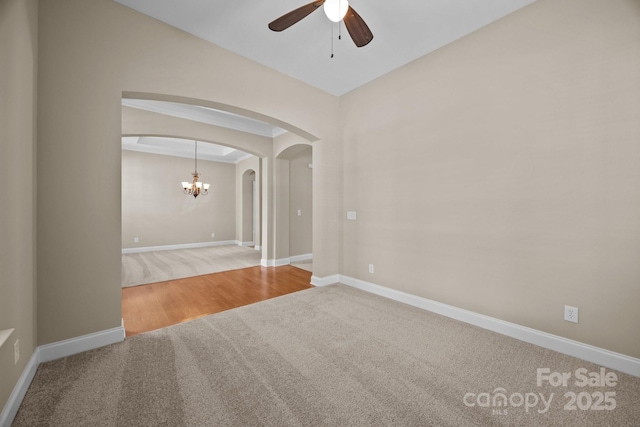 10349 Alvarado Way, Charlotte, NC 28277 - carpeted spare room featuring arched walkways, a ceiling fan, and a chandelier