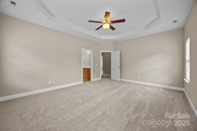 10349 Alvarado Way, Charlotte, NC 28277 - unfurnished bedroom with a tray ceiling, multiple windows, and light colored carpet