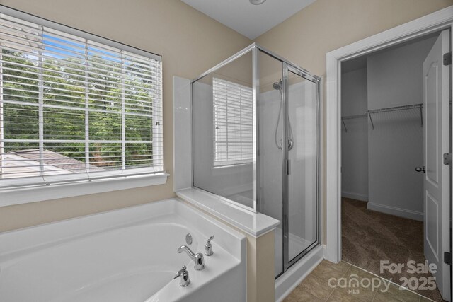10349 Alvarado Way, Charlotte, NC 28277 - bathroom with plenty of natural light, a shower stall, a bath, and a walk in closet