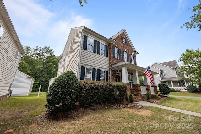 10349 Alvarado Way, Charlotte, NC 28277 - view of front of house featuring brick siding, a front yard, and a porch