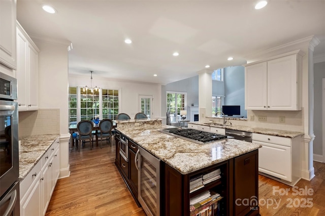 12644 Lahinch Ct, Charlotte, NC 28277 - kitchen featuring stainless steel appliances, wine cooler, recessed lighting, white cabinets, and light wood finished floors