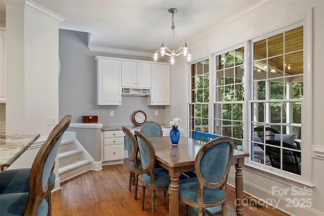 12644 Lahinch Ct, Charlotte, NC 28277 - dining room with a chandelier, light wood-style floors, and ornamental molding