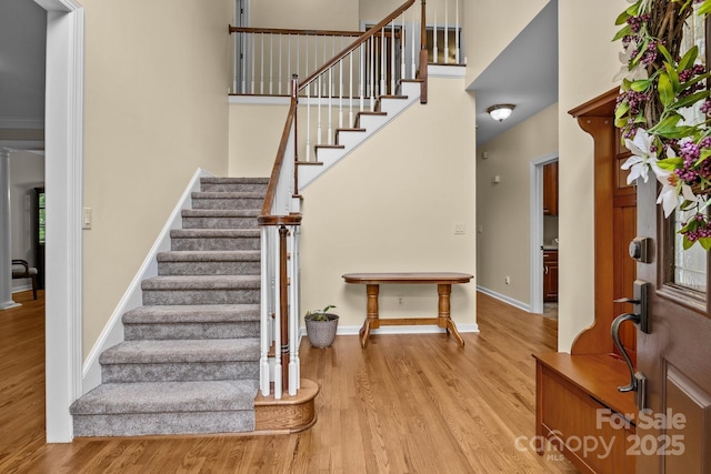 17433 Glassfield Dr, Huntersville, NC 28078 - foyer entrance with wood finished floors, stairway, a high ceiling, and decorative columns