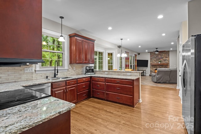 17433 Glassfield Dr, Huntersville, NC 28078 - kitchen with stainless steel appliances, open floor plan, ceiling fan, a peninsula, and light wood finished floors