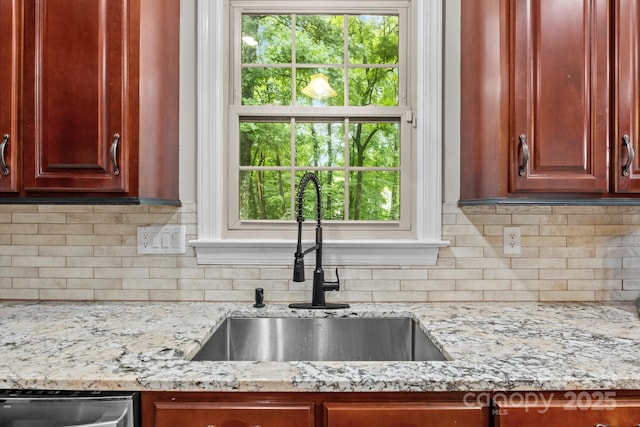 17433 Glassfield Dr, Huntersville, NC 28078 - kitchen with light stone countertops, reddish brown cabinets, backsplash, and stainless steel dishwasher