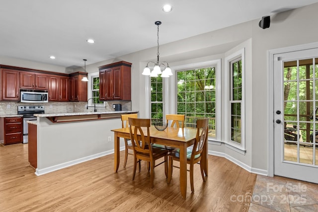 17433 Glassfield Dr, Huntersville, NC 28078 - dining space with light wood-type flooring, a chandelier, and recessed lighting