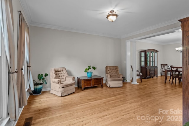 17433 Glassfield Dr, Huntersville, NC 28078 - living area with ornamental molding, light wood finished floors, decorative columns, and a chandelier