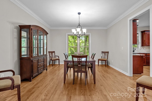 17433 Glassfield Dr, Huntersville, NC 28078 - dining room featuring light wood finished floors, crown molding, and a chandelier