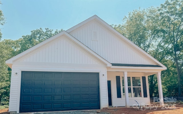 118 3rd Ave NW, Conover, NC 28613 - view of front of home with a porch, a garage, and board and batten siding