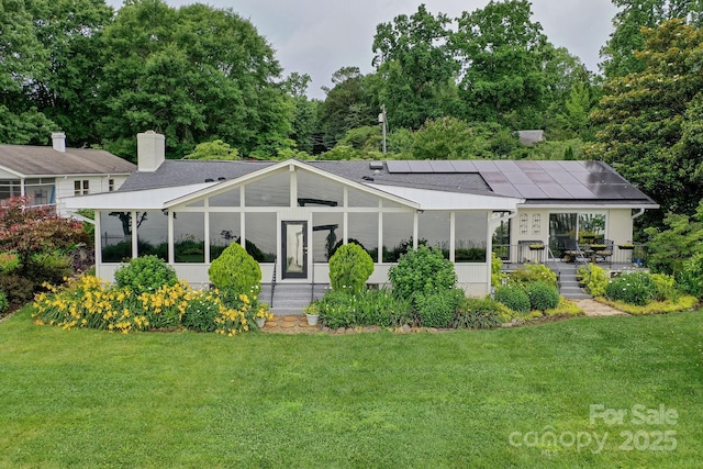 7945 Placid Ct, Denver, NC 28037 - rear view of house featuring a lawn, roof mounted solar panels, and a chimney