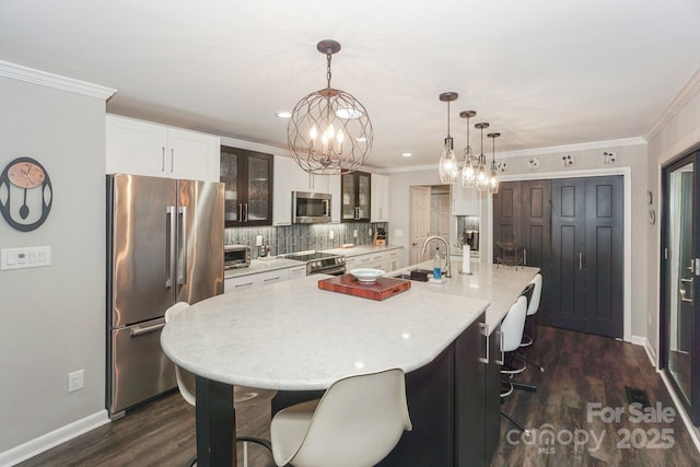 7945 Placid Ct, Denver, NC 28037 - kitchen with appliances with stainless steel finishes, dark wood finished floors, light countertops, tasteful backsplash, and crown molding