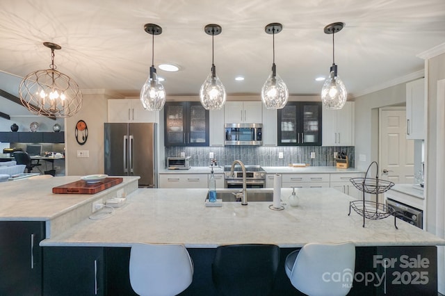 7945 Placid Ct, Denver, NC 28037 - kitchen featuring appliances with stainless steel finishes, a spacious island, decorative backsplash, crown molding, and glass insert cabinets
