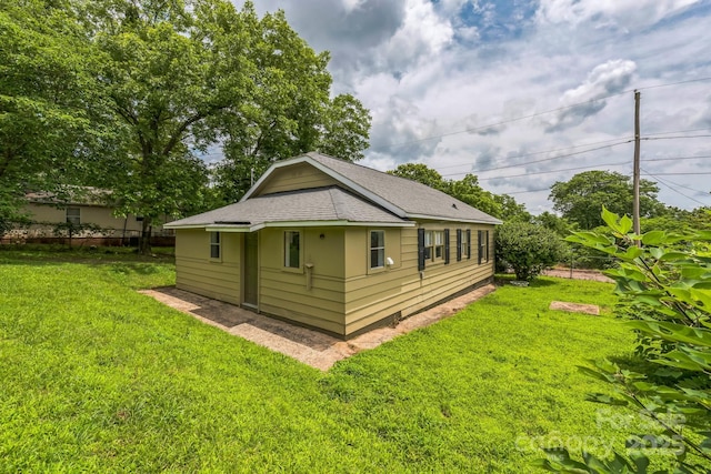 807 3rd St, Kings Mountain, NC 28086 - view of home's exterior with a shingled roof and a yard