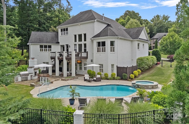 109 Walking Horse Trl, Davidson, NC 28036 - back of house featuring an outdoor kitchen, a fenced backyard, a patio, a deck, and stucco siding