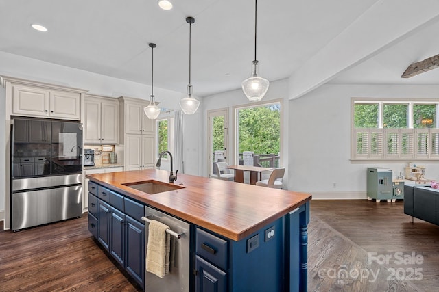 109 Walking Horse Trl, Davidson, NC 28036 - kitchen featuring blue cabinets, refrigerator, butcher block countertops, healthy amount of natural light, and recessed lighting