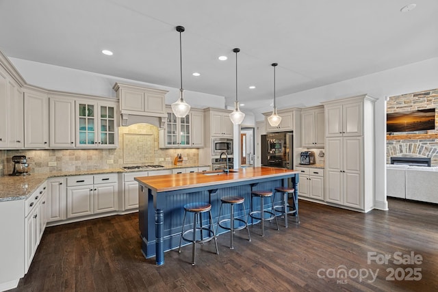 109 Walking Horse Trl, Davidson, NC 28036 - kitchen featuring stainless steel microwave, gas cooktop, dark wood-style flooring, tasteful backsplash, and recessed lighting