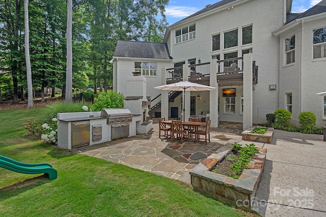 109 Walking Horse Trl, Davidson, NC 28036 - rear view of house featuring exterior kitchen, a patio, a yard, and stairway