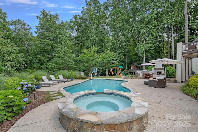 109 Walking Horse Trl, Davidson, NC 28036 - view of pool with a patio, a playground, an outdoor fireplace, and a pool with connected hot tub