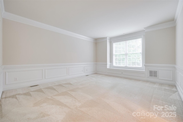 5008 Woodview Ln, Weddington, NC 28104 - empty room with light colored carpet, a wainscoted wall, crown molding, and a decorative wall