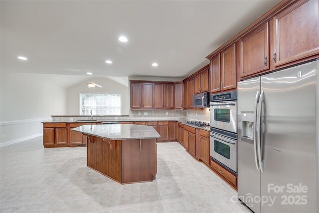5008 Woodview Ln, Weddington, NC 28104 - kitchen with appliances with stainless steel finishes, a sink, light stone countertops, tasteful backsplash, and brown cabinetry