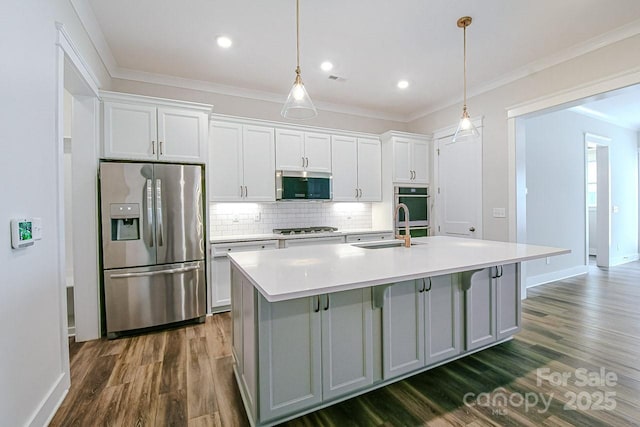 4714 Blanchard Way, Charlotte, NC 28226 - kitchen featuring appliances with stainless steel finishes, dark wood-style floors, a sink, a kitchen island with sink, and ornamental molding