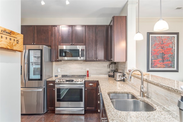 5 Farleigh St Unit 303, Asheville, NC 28803 - kitchen featuring stainless steel appliances, light stone counters, decorative backsplash, dark brown cabinets, and pendant lighting