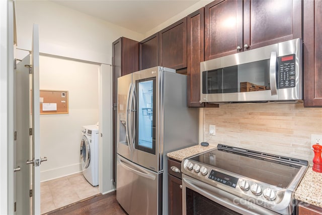 5 Farleigh St Unit 303, Asheville, NC 28803 - kitchen with stainless steel appliances, independent washer and dryer, dark brown cabinets, decorative backsplash, and light stone counters