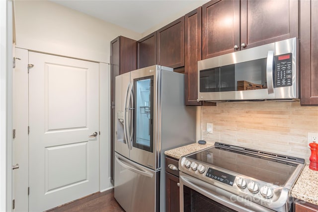 5 Farleigh St Unit 303, Asheville, NC 28803 - kitchen with stainless steel appliances, dark brown cabinetry, tasteful backsplash, and light stone counters
