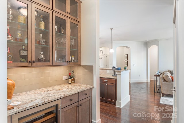 5 Farleigh St Unit 303, Asheville, NC 28803 - bar featuring arched walkways, dark wood-style flooring, decorative backsplash, ornamental molding, and beverage cooler