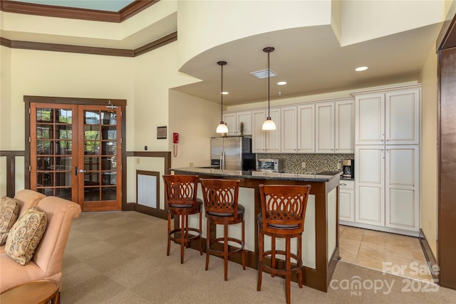 5 Farleigh St Unit 303, Asheville, NC 28803 - kitchen featuring stainless steel fridge with ice dispenser, french doors, a breakfast bar, light carpet, and recessed lighting