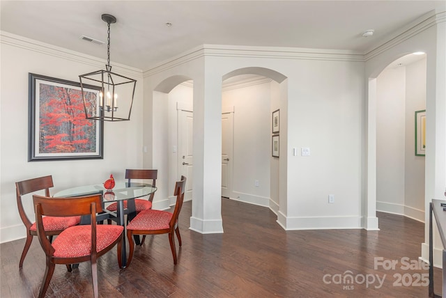 5 Farleigh St Unit 303, Asheville, NC 28803 - dining space featuring dark wood finished floors, a chandelier, arched walkways, and crown molding
