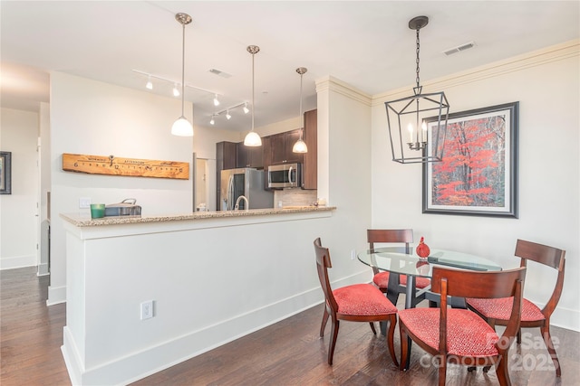 5 Farleigh St Unit 303, Asheville, NC 28803 - dining area with a chandelier, dark wood-style flooring, and rail lighting