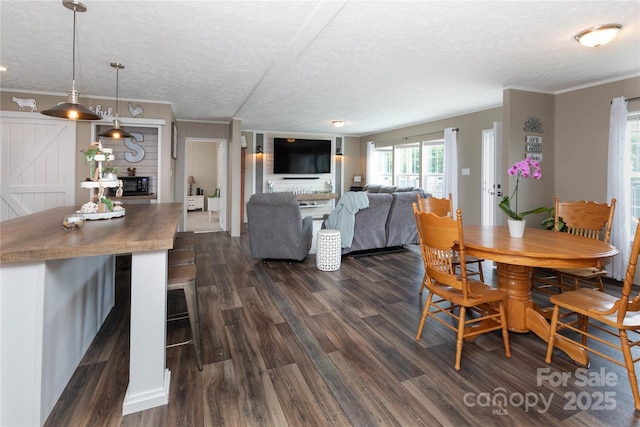 600 Old Mars Hill Hwy, Weaverville, NC 28787 - dining area with dark wood-style floors, a textured ceiling, and crown molding