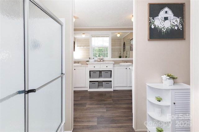 600 Old Mars Hill Hwy, Weaverville, NC 28787 - bathroom with double vanity, a shower stall, wood finished floors, and crown molding