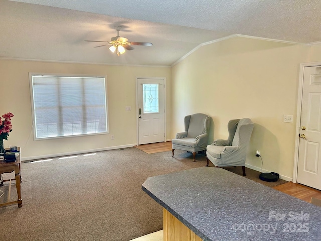 1700 Pickwick Ave, Kannapolis, NC 28083 - carpeted living room featuring crown molding, ceiling fan, baseboards, a textured ceiling, and wood finished floors
