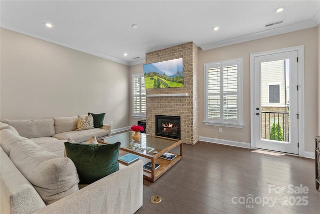 318 N Dotger Ave, Charlotte, NC 28204 - living area with ornamental molding, dark wood-type flooring, a fireplace, and recessed lighting