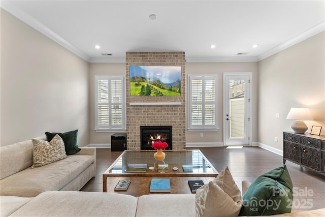 318 N Dotger Ave, Charlotte, NC 28204 - living room with wood finished floors, ornamental molding, a brick fireplace, and recessed lighting