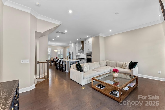 318 N Dotger Ave, Charlotte, NC 28204 - living area with dark wood-type flooring, recessed lighting, and crown molding