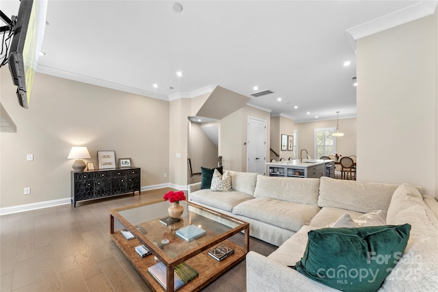 318 N Dotger Ave, Charlotte, NC 28204 - living room with wood finished floors, crown molding, and recessed lighting