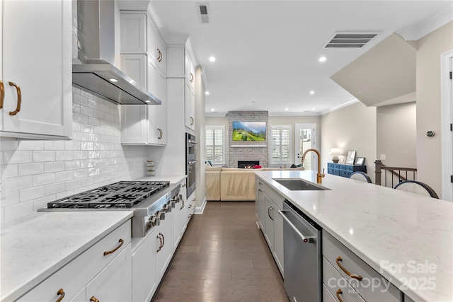 318 N Dotger Ave, Charlotte, NC 28204 - kitchen with appliances with stainless steel finishes, wall chimney exhaust hood, open floor plan, light stone countertops, and recessed lighting