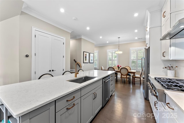 318 N Dotger Ave, Charlotte, NC 28204 - kitchen featuring ventilation hood, stainless steel appliances, ornamental molding, a center island with sink, and white cabinetry