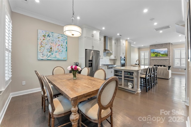 318 N Dotger Ave, Charlotte, NC 28204 - dining room featuring recessed lighting, dark wood finished floors, crown molding, and a fireplace