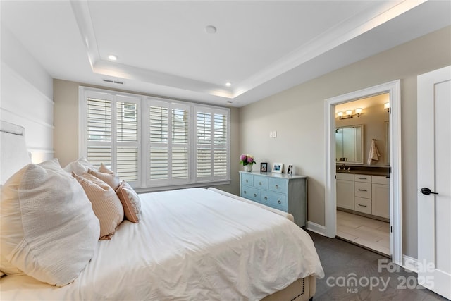 318 N Dotger Ave, Charlotte, NC 28204 - bedroom with a tray ceiling, recessed lighting, ensuite bath, and dark colored carpet