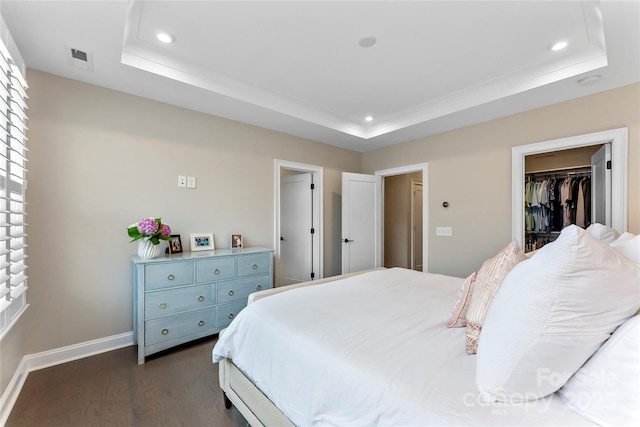 318 N Dotger Ave, Charlotte, NC 28204 - bedroom featuring a raised ceiling, recessed lighting, dark wood-style flooring, a spacious closet, and a closet