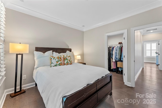318 N Dotger Ave, Charlotte, NC 28204 - bedroom with dark wood-style floors, a walk in closet, ornamental molding, and a closet