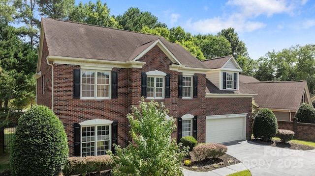 7213 Baniff Cir, Charlotte, NC 28277 - colonial home featuring concrete driveway, brick siding, an attached garage, and roof with shingles