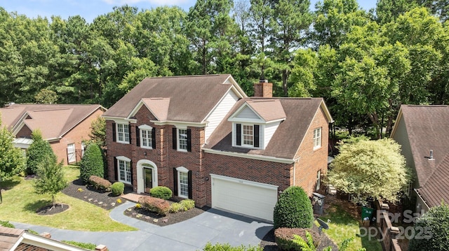 7213 Baniff Cir, Charlotte, NC 28277 - colonial house with concrete driveway, a garage, brick siding, and a chimney