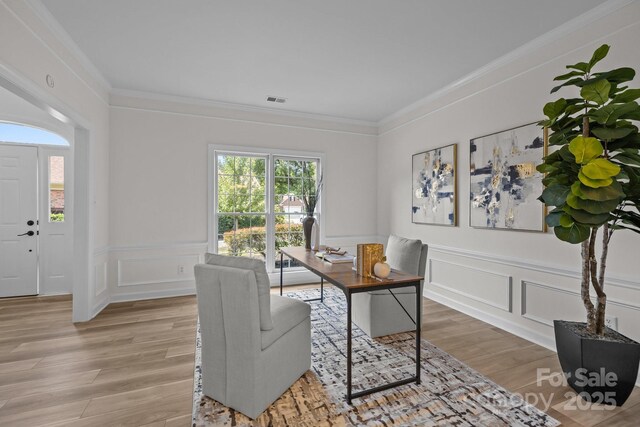 7213 Baniff Cir, Charlotte, NC 28277 - office area featuring light wood-type flooring, a decorative wall, crown molding, and a wainscoted wall